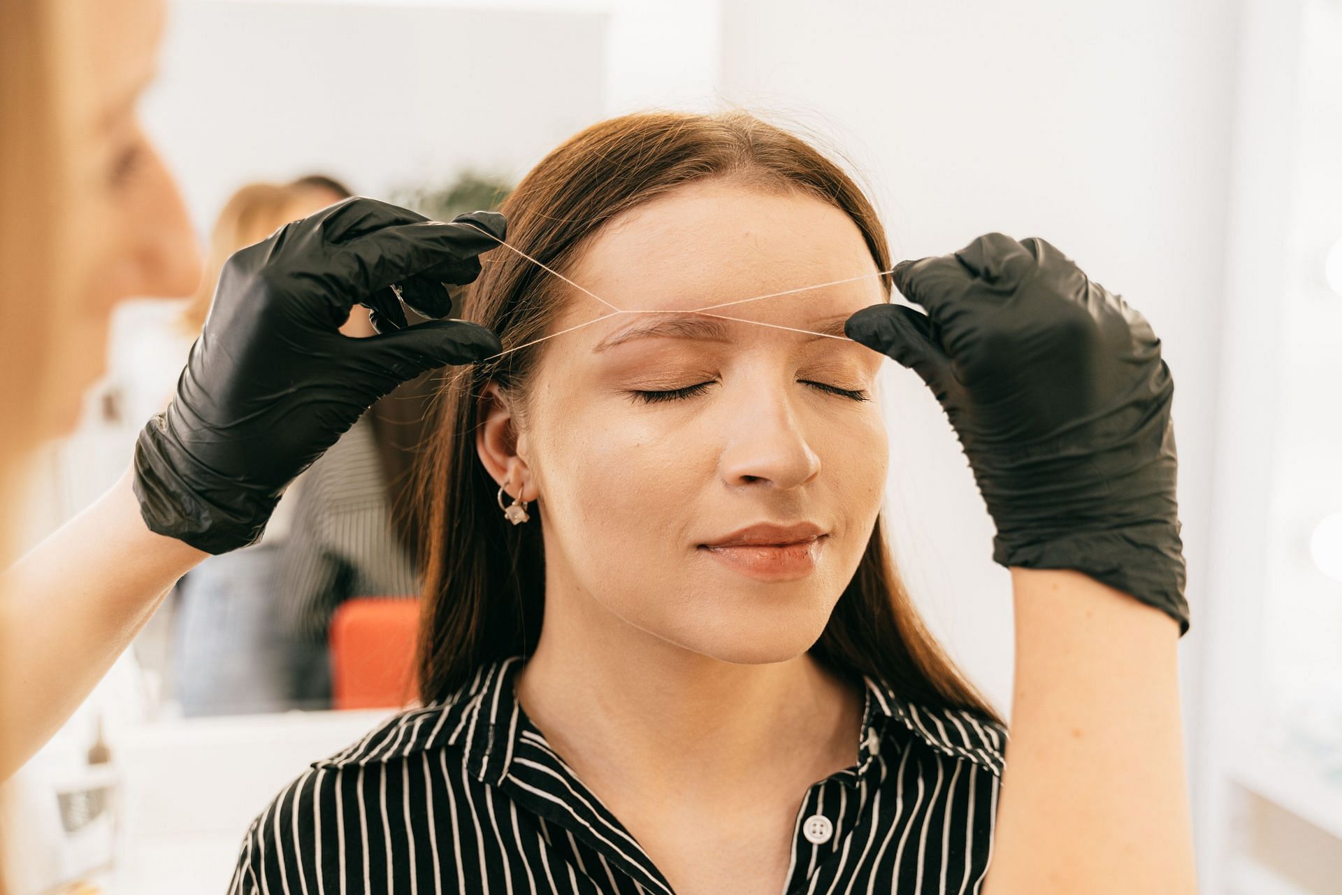 Threading is one of the best facial hair removal methods (Image via Pexels/Antoni Shkraba)