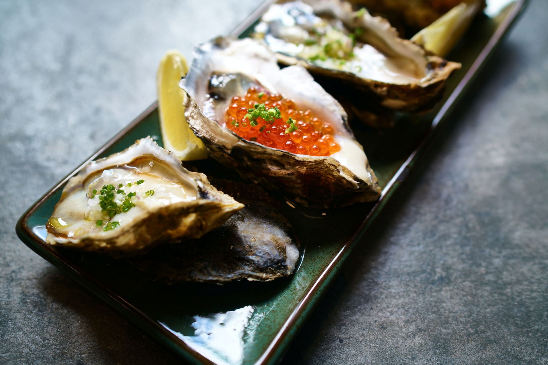 Oysters can be eaten raw or cooked. (Image via Unsplash/Bruce Chapman)