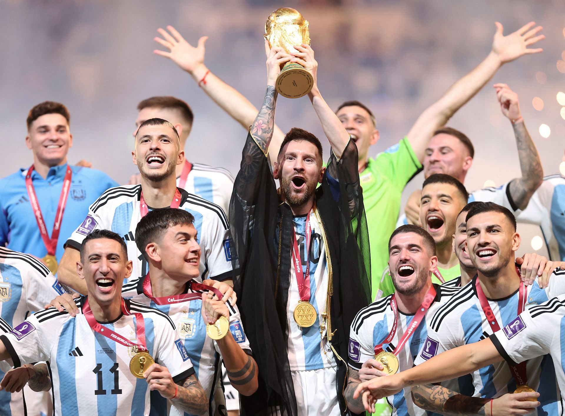 Lionel Messi and his team celebrate with the World Cup trophy