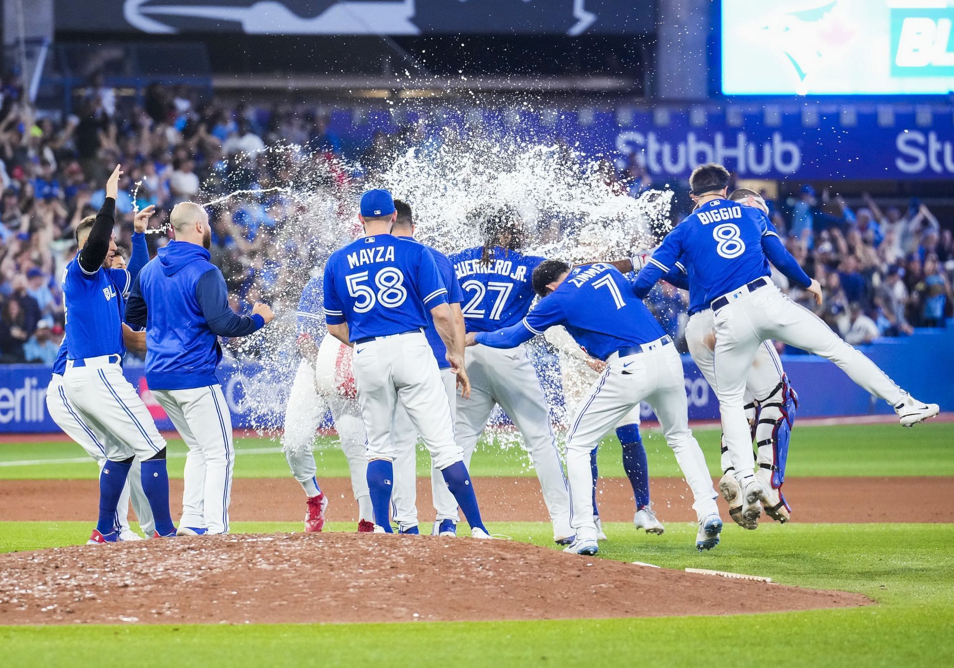 Teammates splash Vladimir Guerrero Jr.  of the Toronto Blue Jays with water after his walk-off hit to defeat the New York Yankees.