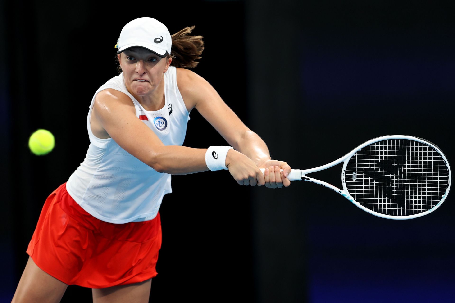 Iga Swiatek plays a backhand in her semi-final match against Jessica Pegula