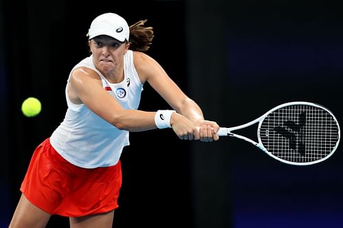 Iga Swiatek plays a backhand in her semi-final match against Jessica Pegula