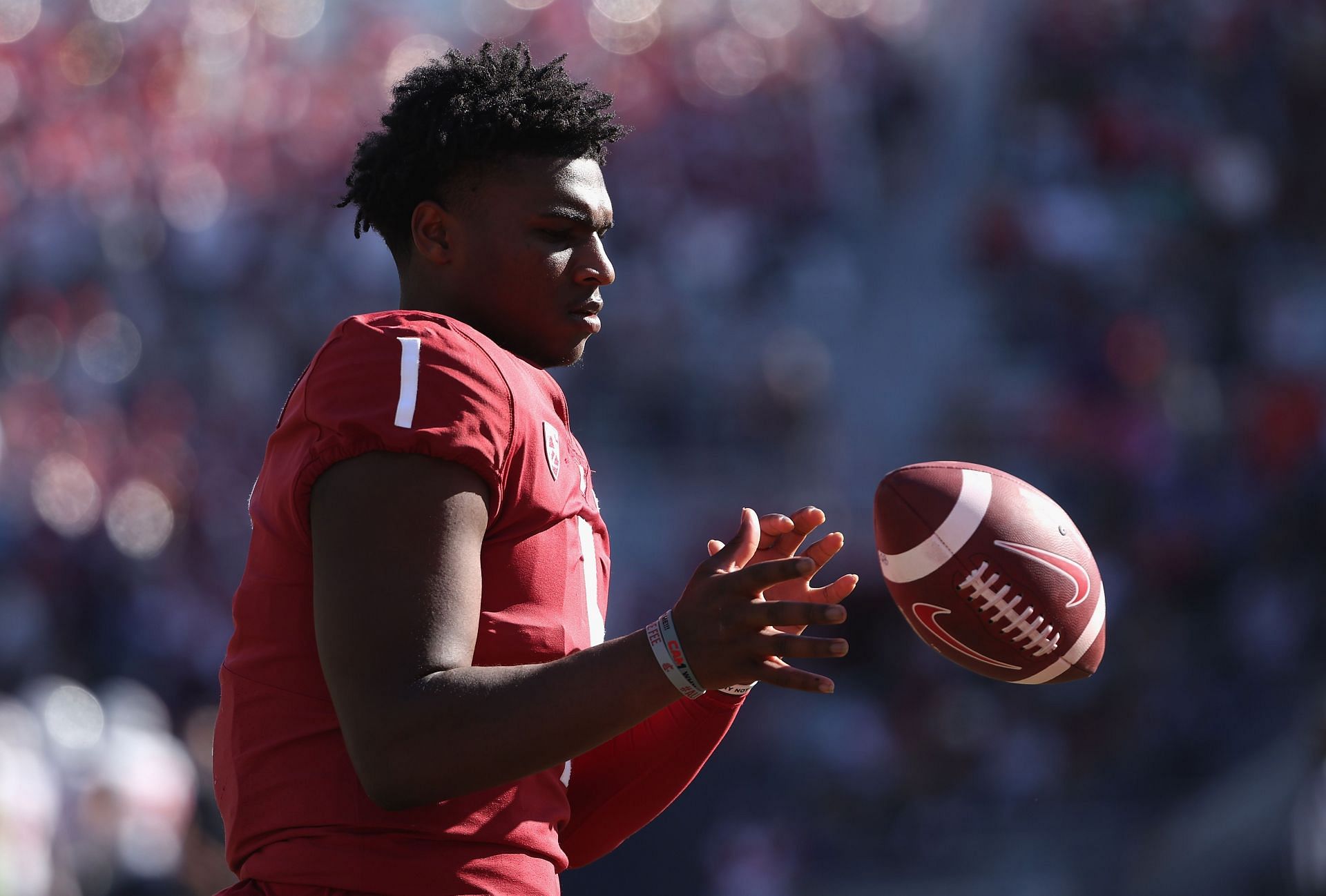 Quarterback Cameron Ward of the Washington State Cougars warms up on the sidelines during the second half of the NCAAF game against the Arizona Wildcats