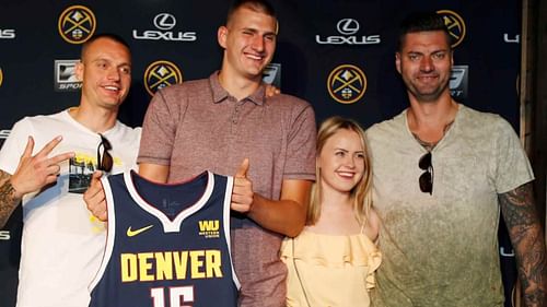 Nikola Jokic with his wife Natalija Mačešić at the Denver Nuggets podium