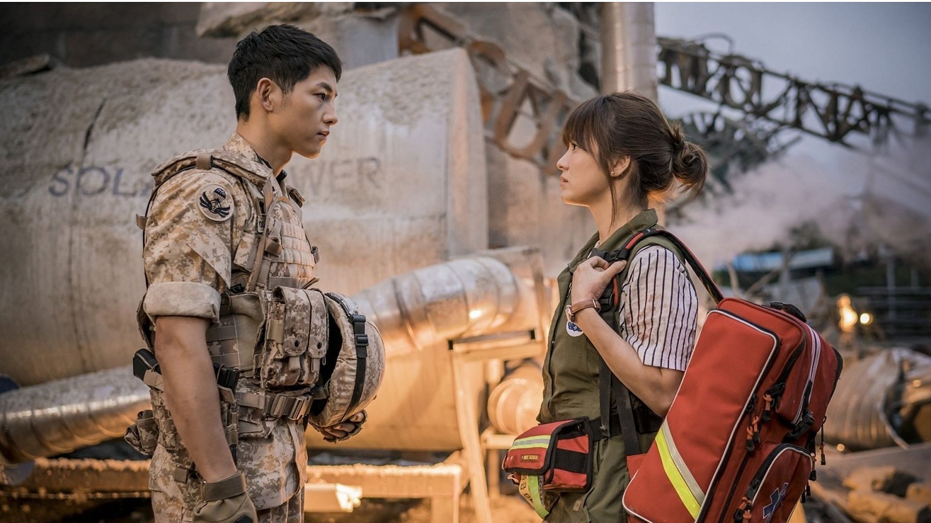 Song Joong-ki and Song Hye-kyo from a still of Descendants in the Sun, facing each other.