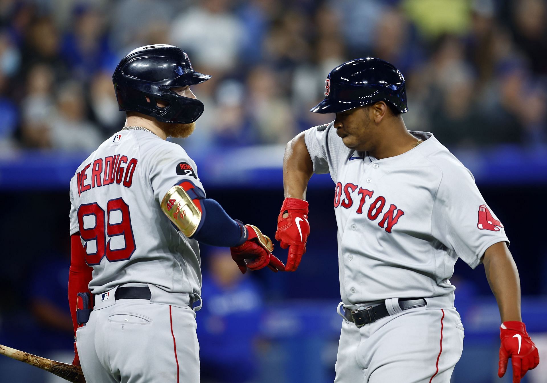 Rafael Devers of the Boston Red Sox celebrates with Alex Verdugo after scoring a run at Rogers Centre