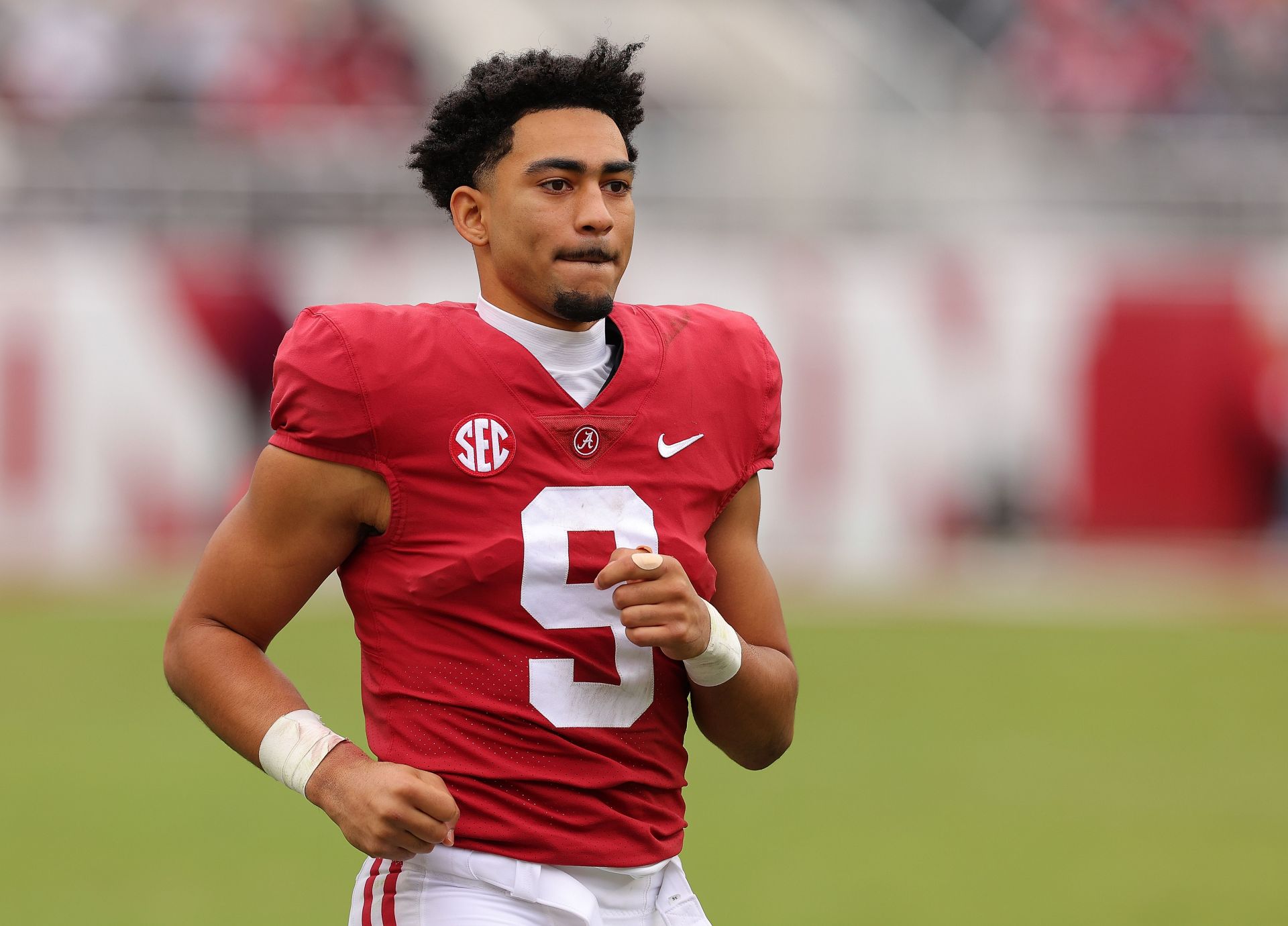 Bryce Young of the Alabama Crimson Tide runs to the offensive huddle in the fourth quarter against the Austin Peay Governors