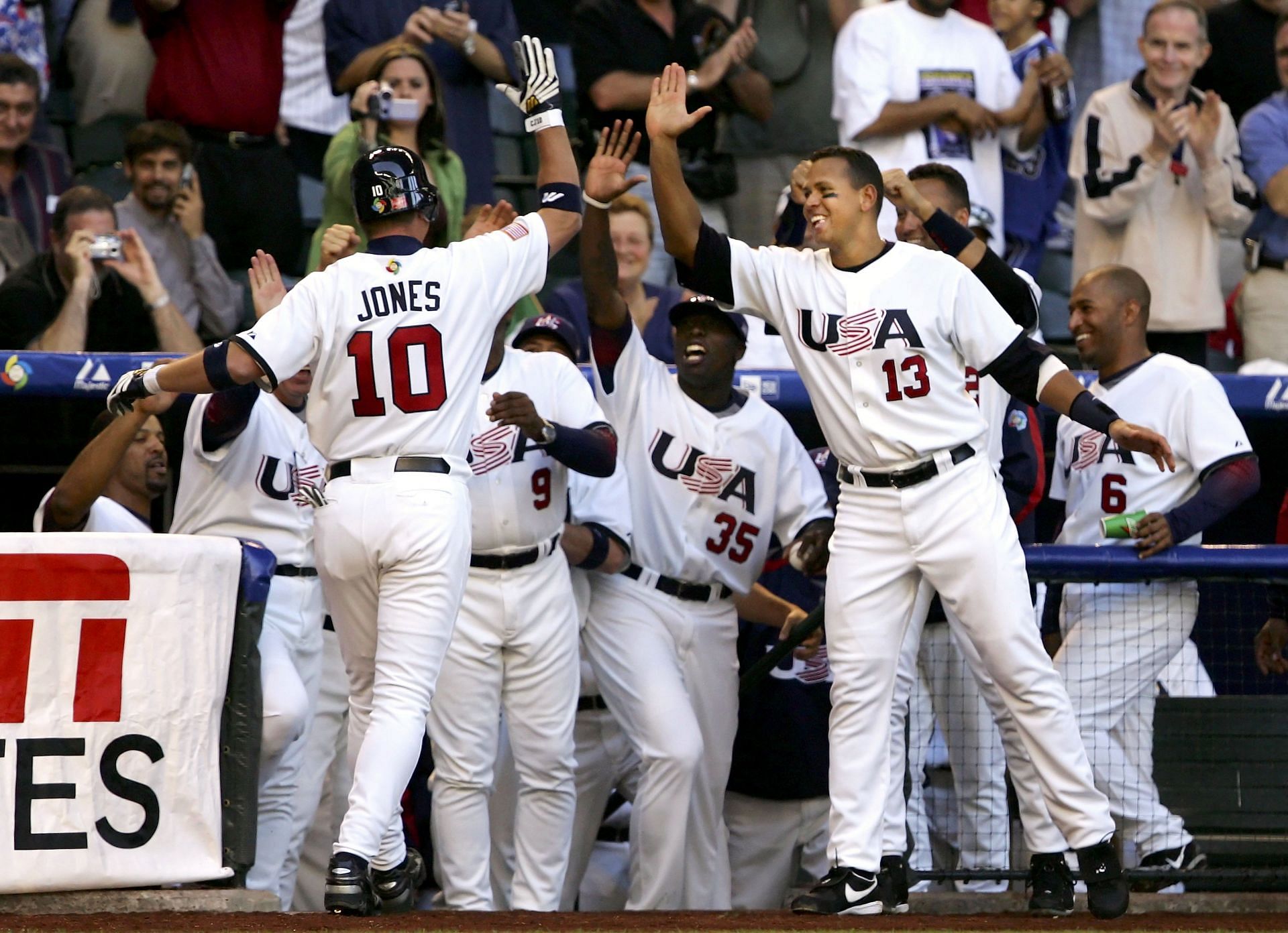 Chipper Jones #10 of Team USA is congratulated by teammates Dontrelle Willis #35 and Alex Rodriguez #13 after hitting a solo home run against Team Mexico during the fourth inning of Round 1 Pool B Game of the World Baseball Classic at Chase Field on March 7 , 2006, in Phoenix, Arizona.  Team USA defeated Team Mexico 2-0. 
