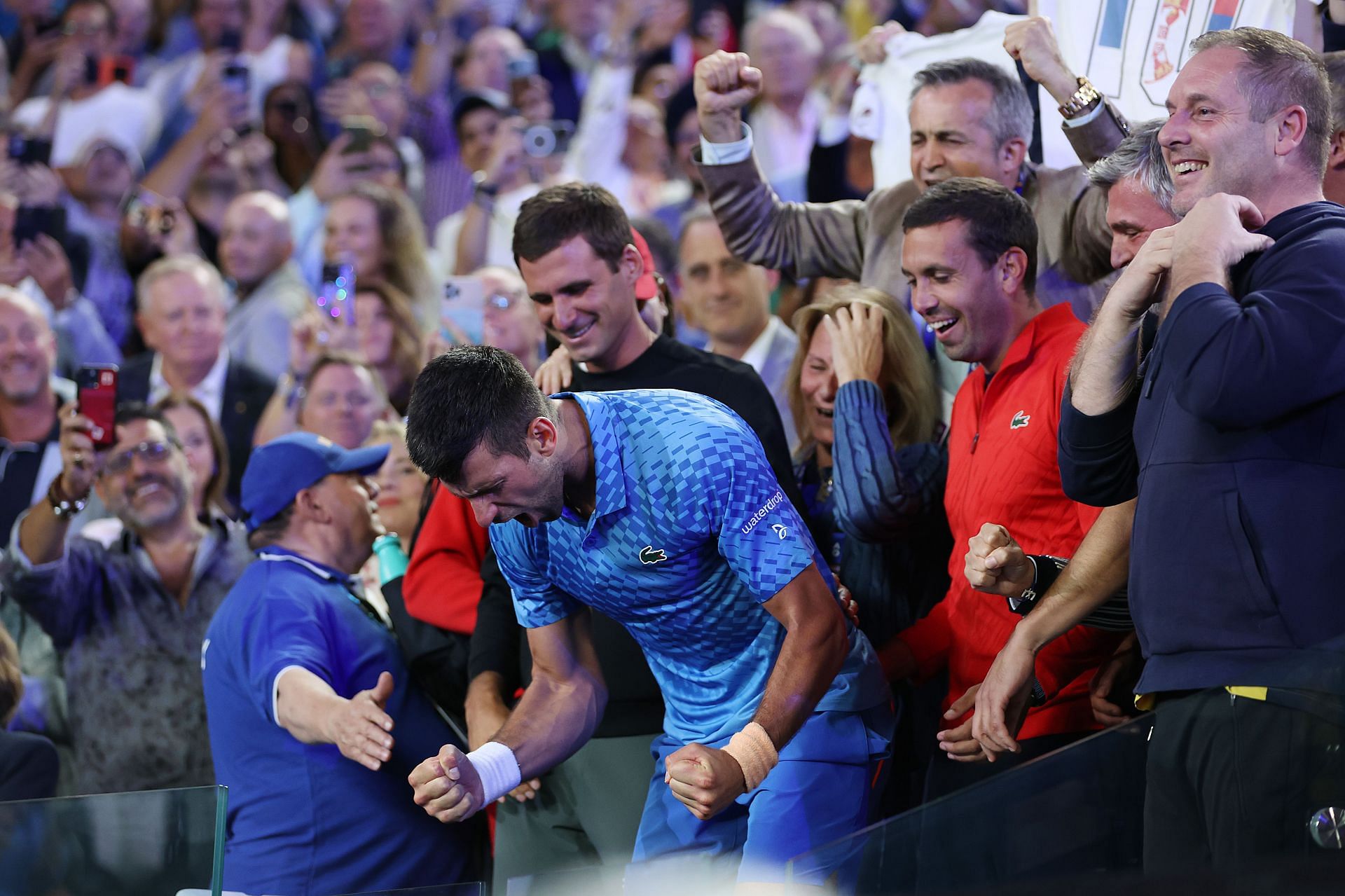 Novak Djokovic celebrating his win at the player&#039;s box