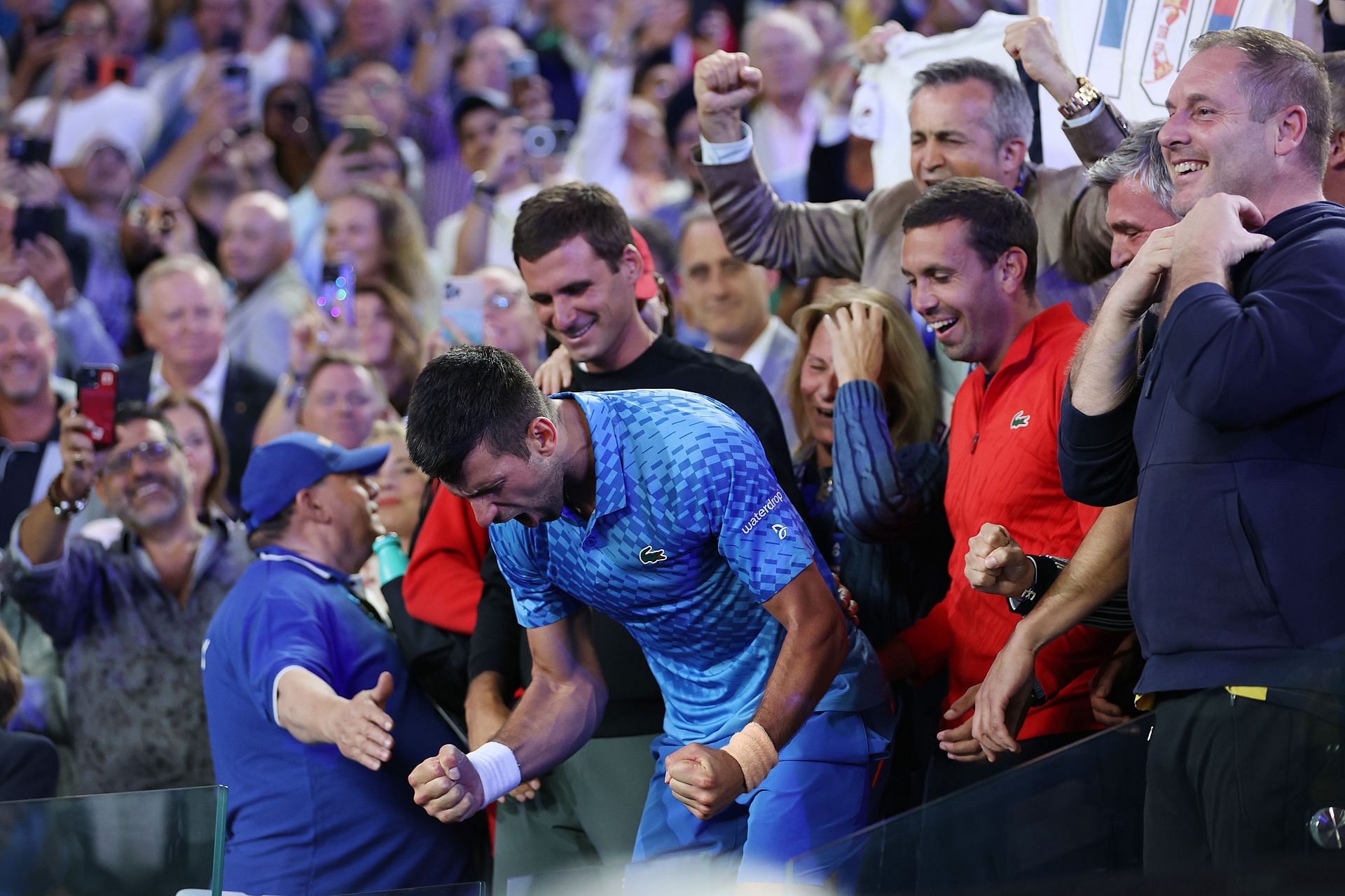 Novak Djokovic celebrating his win at the player's box