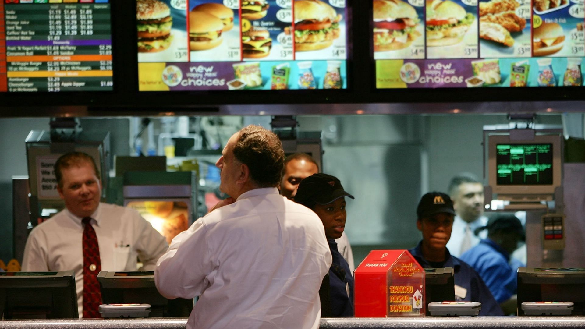 Workers taking the order of a customer at a fast food restaurant (Image via Spencer Platt/Getty Images)