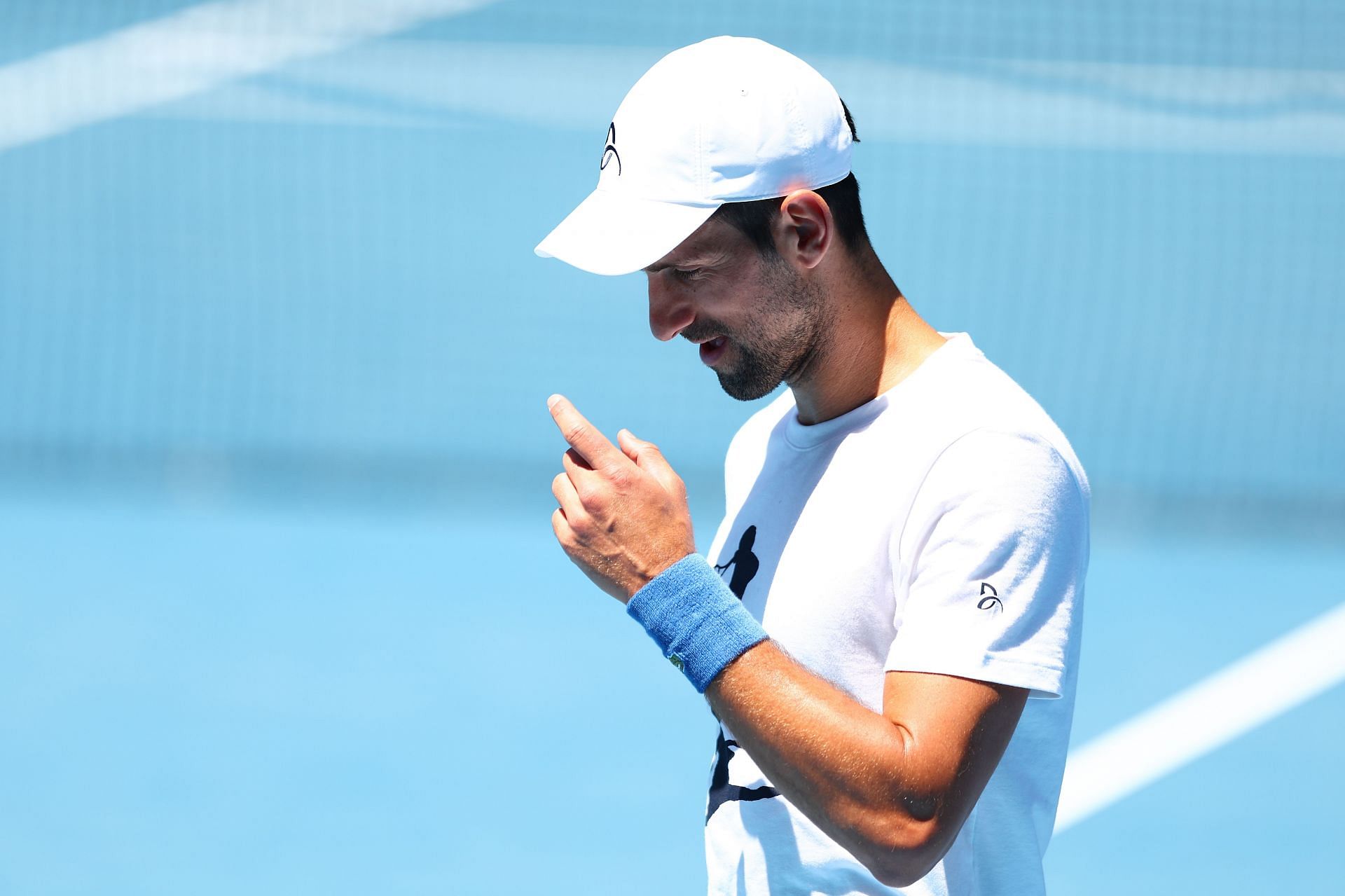 Novak Djokovic looks on during a practice session ahead of the 2023 Australian Open