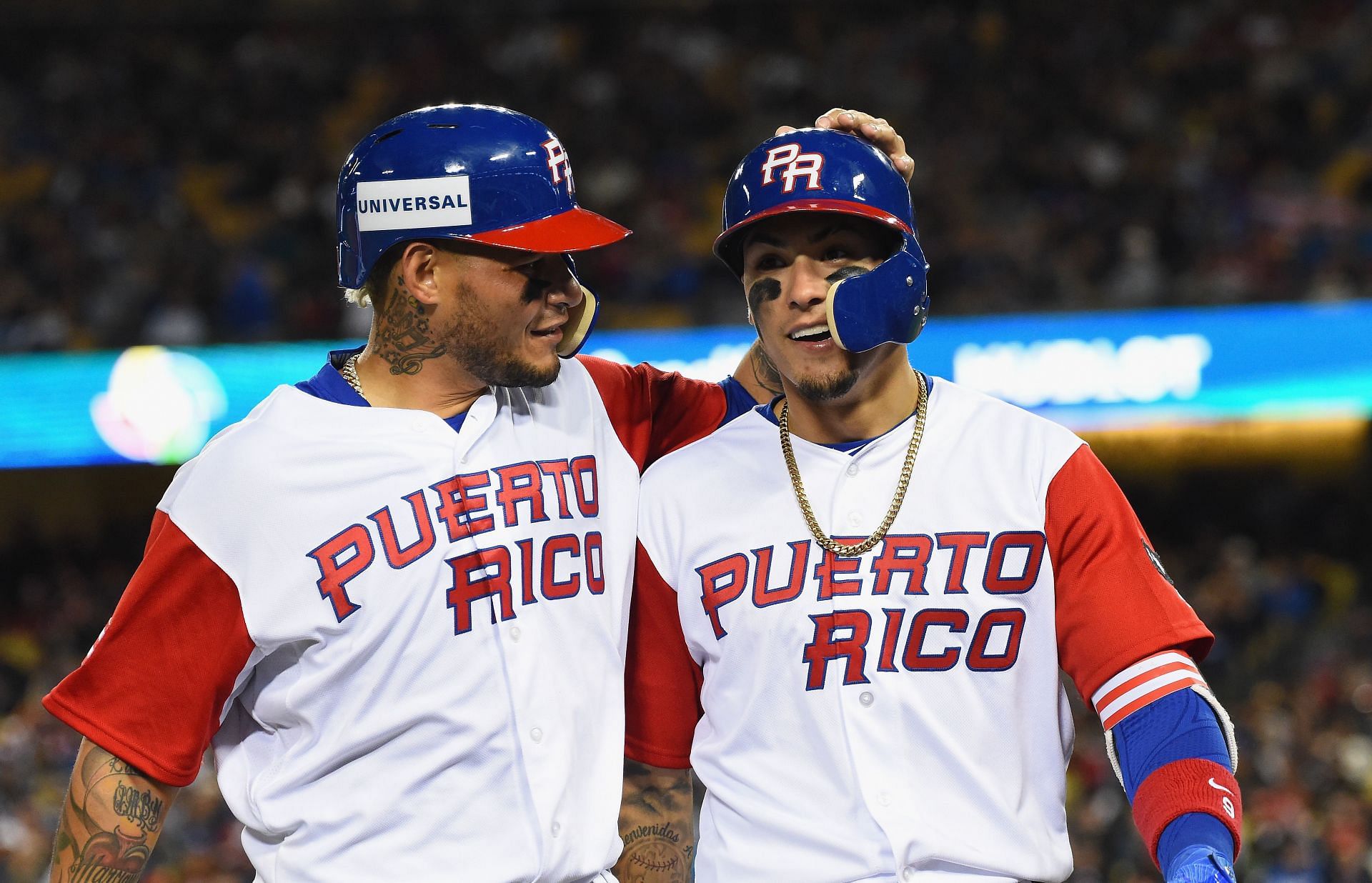 Yadier Molina #4 and Javier Baez #9 of team Puerto Rico walk into the dugout during Game 3 of the Championship Round of the 2017 World Baseball Classic