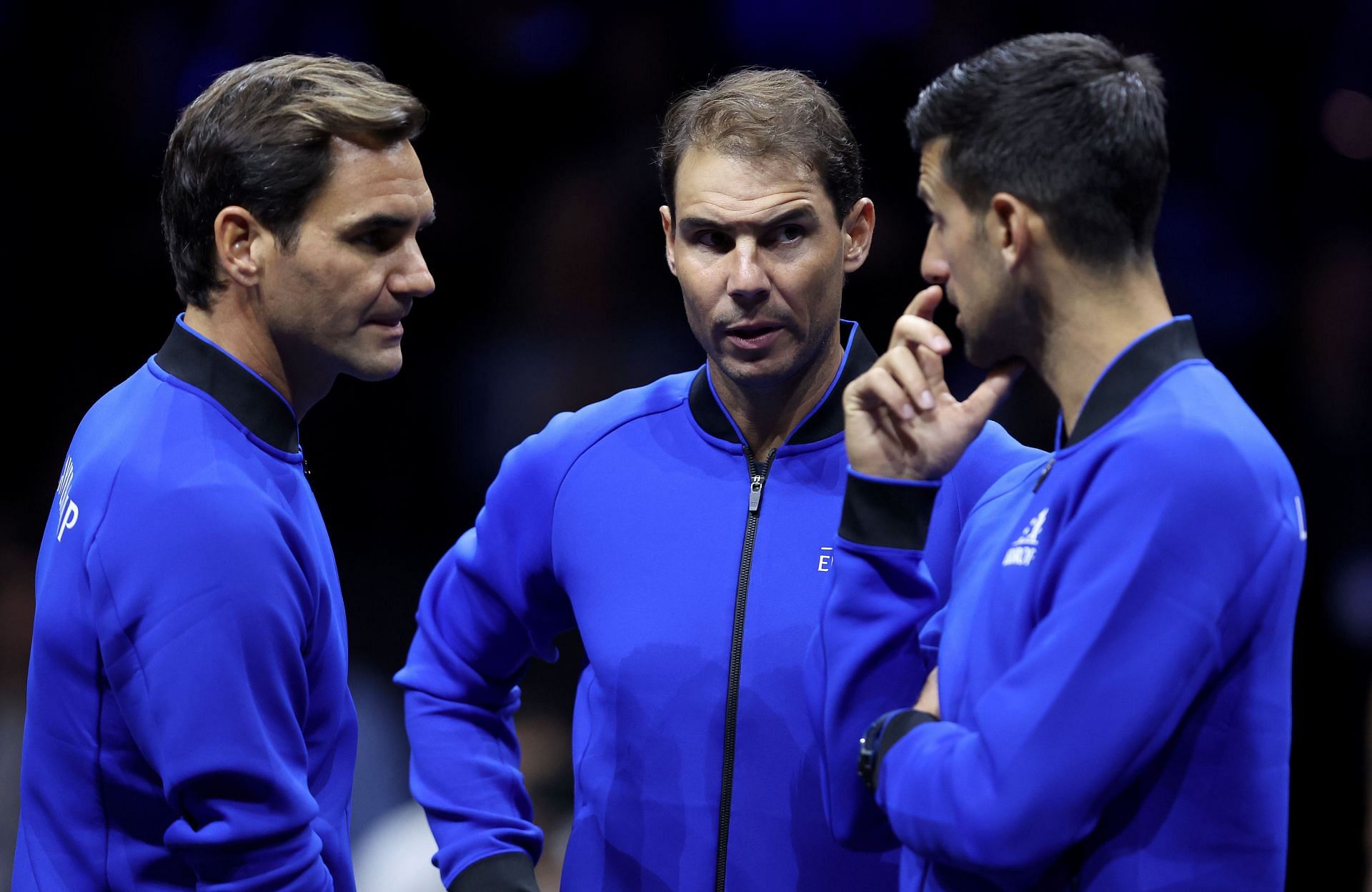Federer interacts with Novak Djokovic