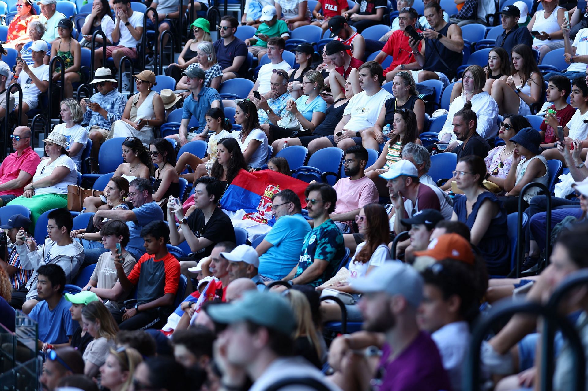 Tennis fans cheer for the Serb during his practice session with Daniil Medvedev on January 11