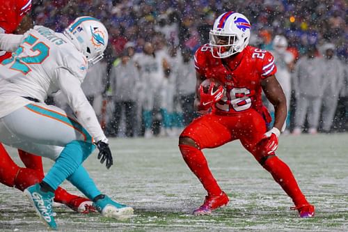 Miami defenders try to tackle Buffalo's Devin Singletary