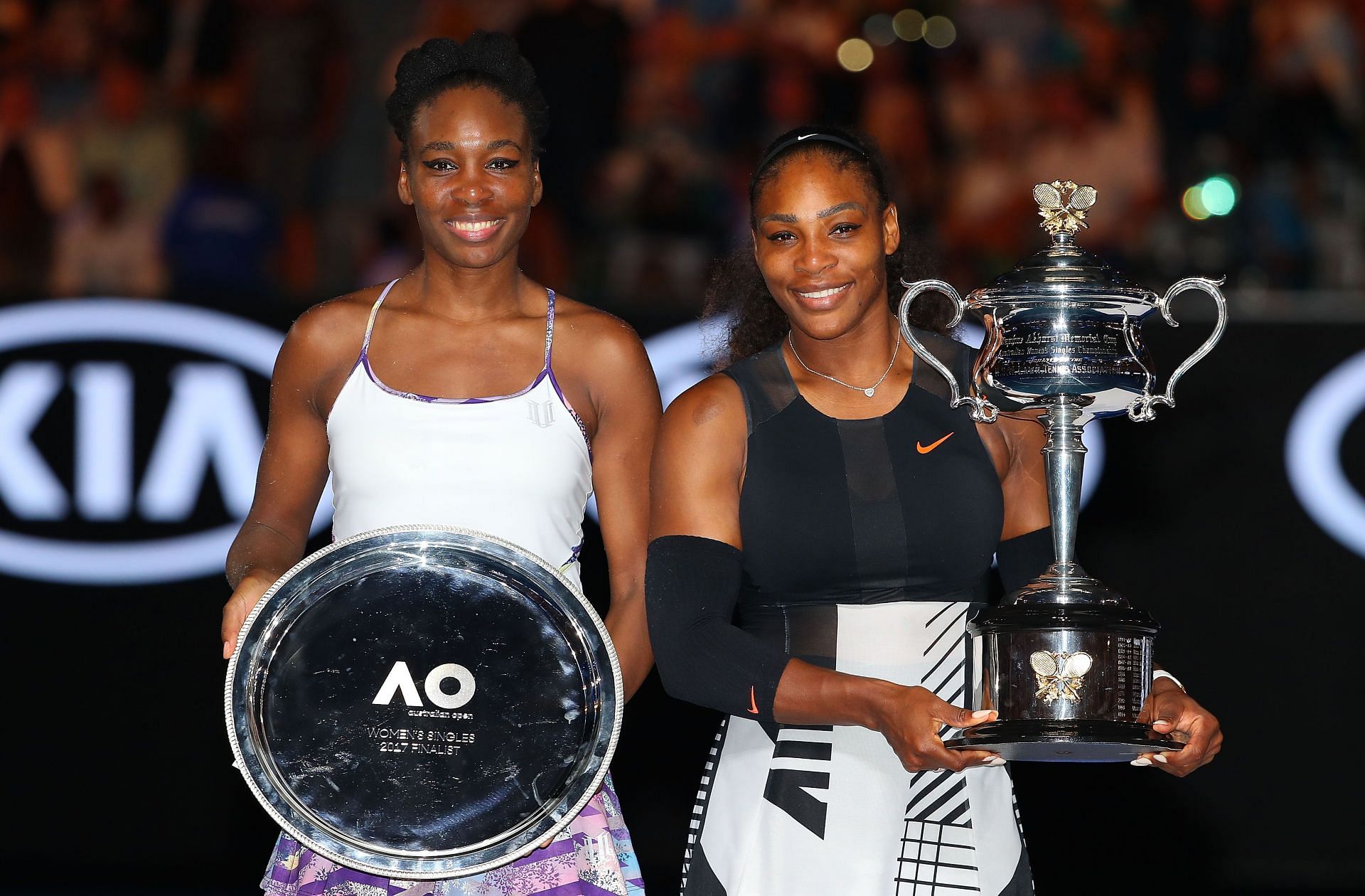 Venus Williams [left] and Serena Williams with their respective Australian Open 2017 trophies