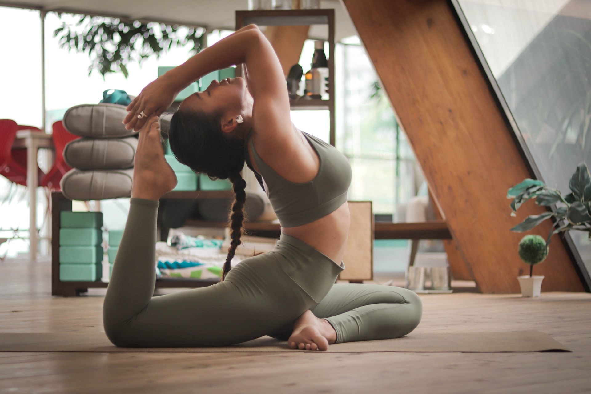 Triangle Pose. Athletic Slim Woman with Hair Bun in Tight Sportswear  Practicing Yoga, Doing Trikonasana Exercise Stock Image - Image of  flexible, harmony: 185884913