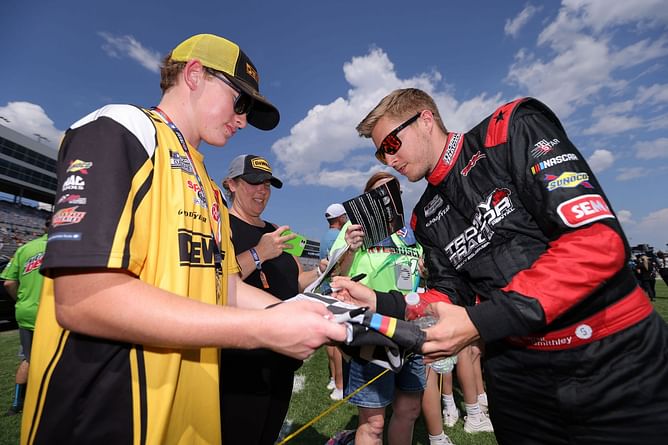 NASCAR Xfinity Series driver Garrett Smithley changes his car number ahead of the race in Daytona