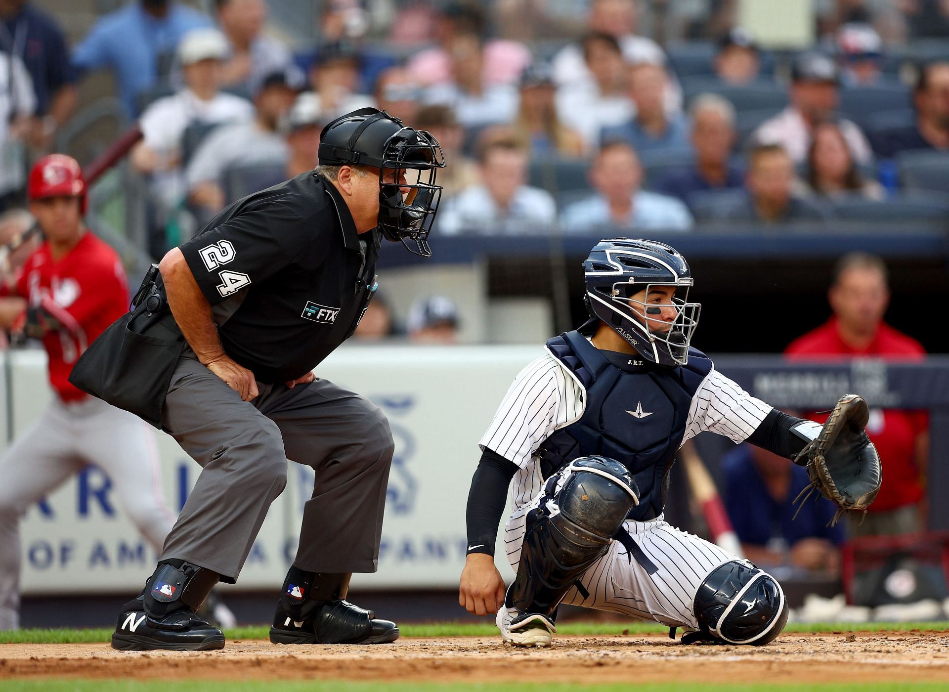 Home plate umpire Jerry Layne works the game as Jose Trevino catches at Yankee Stadium