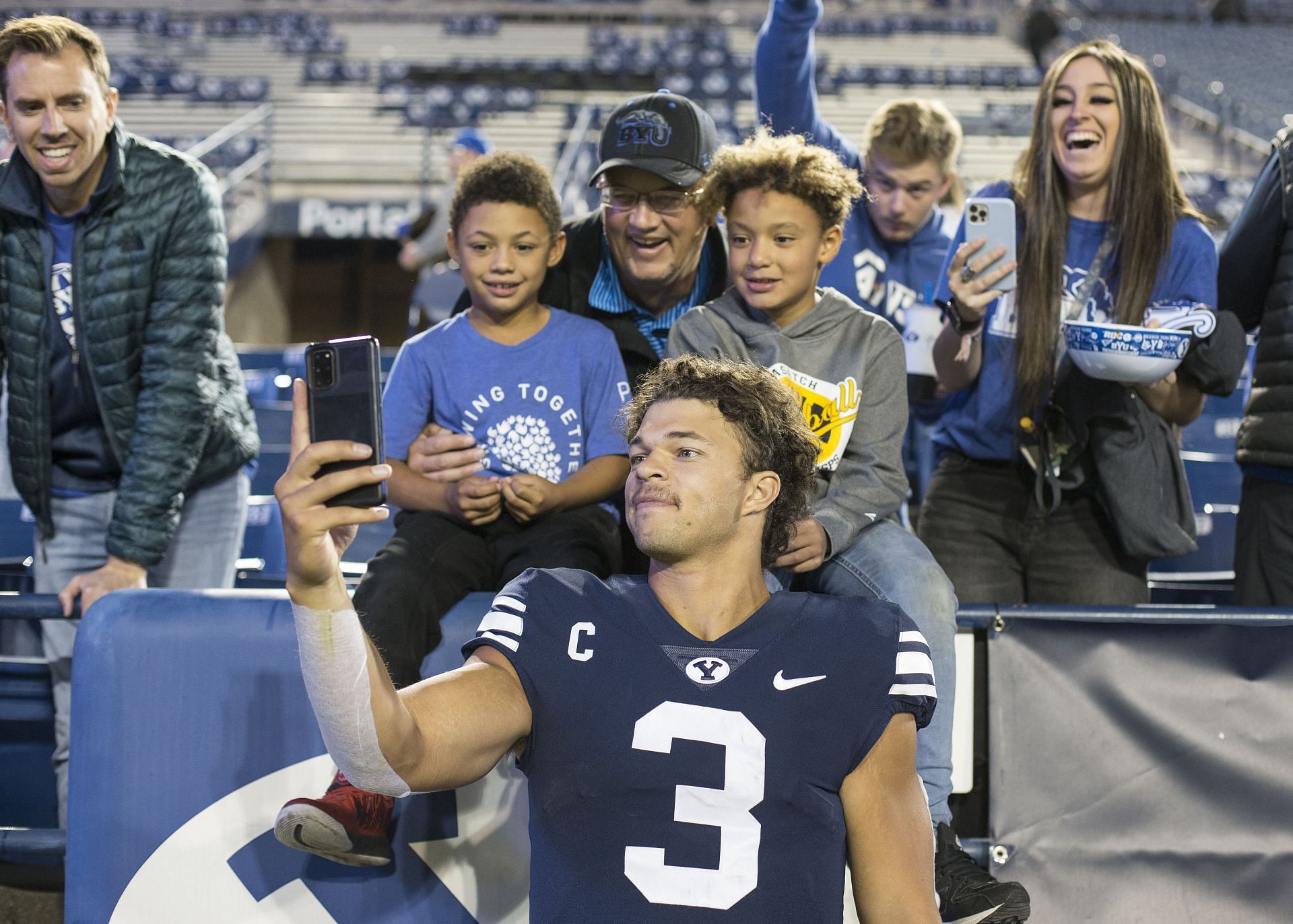 Jaren Hall of the Brigham Young Cougars takes a selfie with fans
