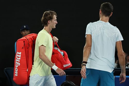 Sebastian Korda [L] walks off the court as Karen Khachanov looks on