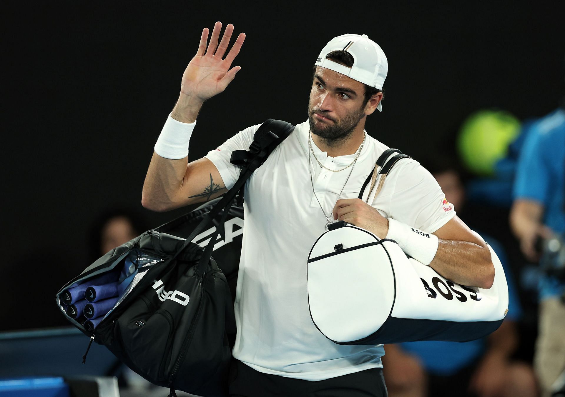 Berrettini leaves the court following his defeat to Andy Murray