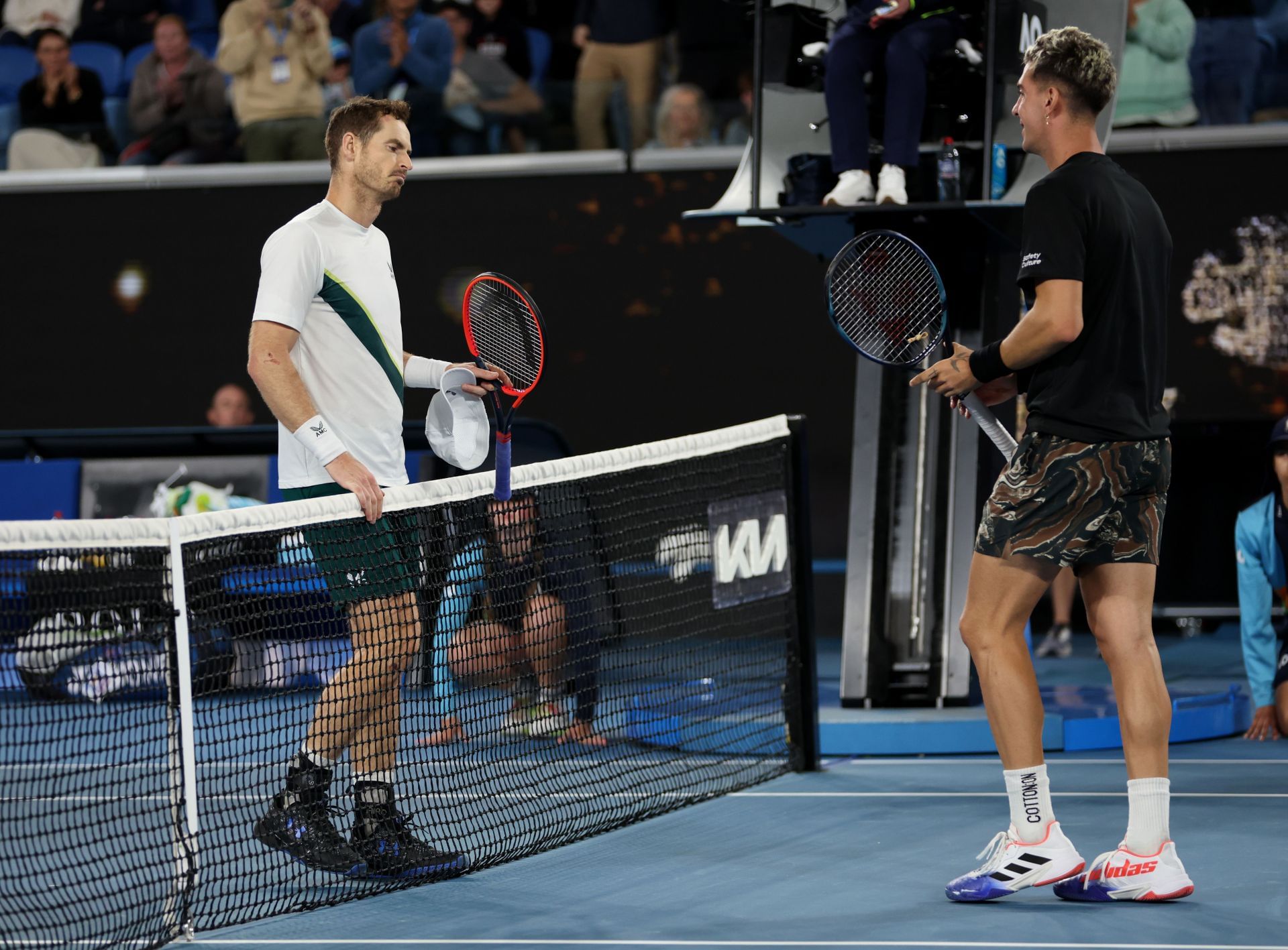 Andy Murray shakes hands at the net after his five-set victory in their round two singles match against Thanasi Kokkinakis