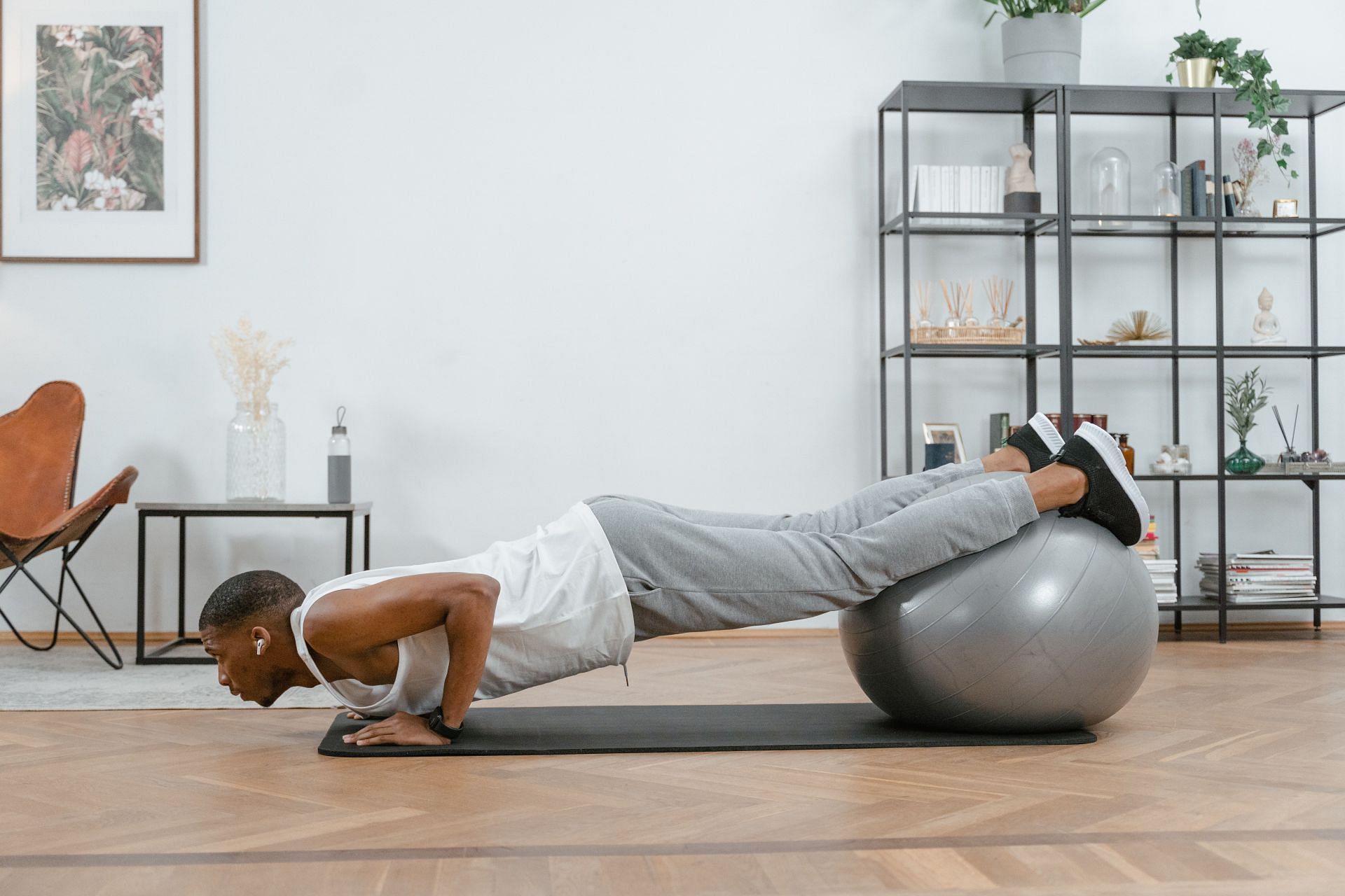 Plank on ball will help you tone your core and abdomen (Image via Pexels/Mart Production)