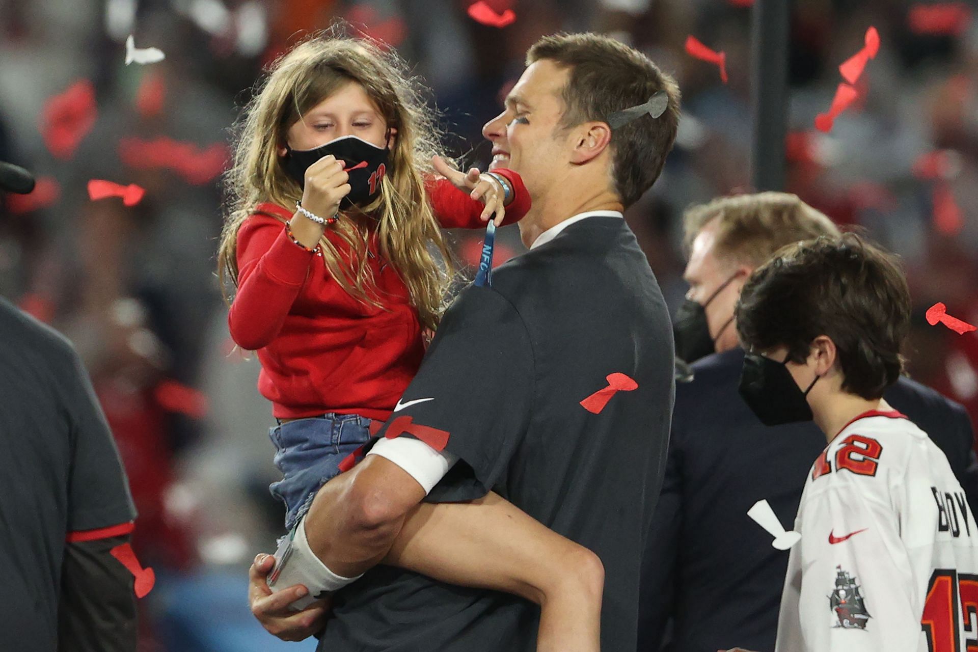 Tom Brady of the Tampa Bay Buccaneers hugs his daughter Vivian after defeating the Kansas City Chiefs 31-9 in Super Bowl LV