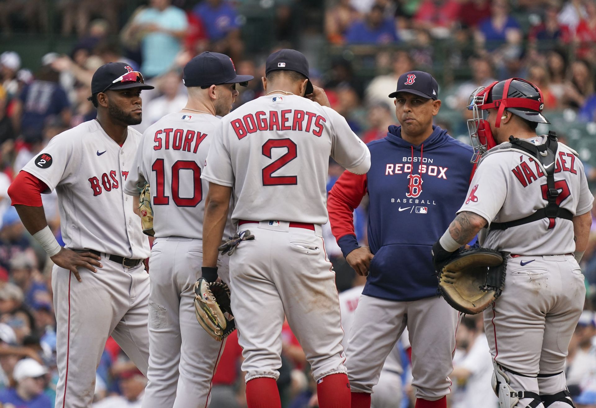 Manager Alex Cora visits the mound during a game against the Chicago Cubs at Wrigley Field