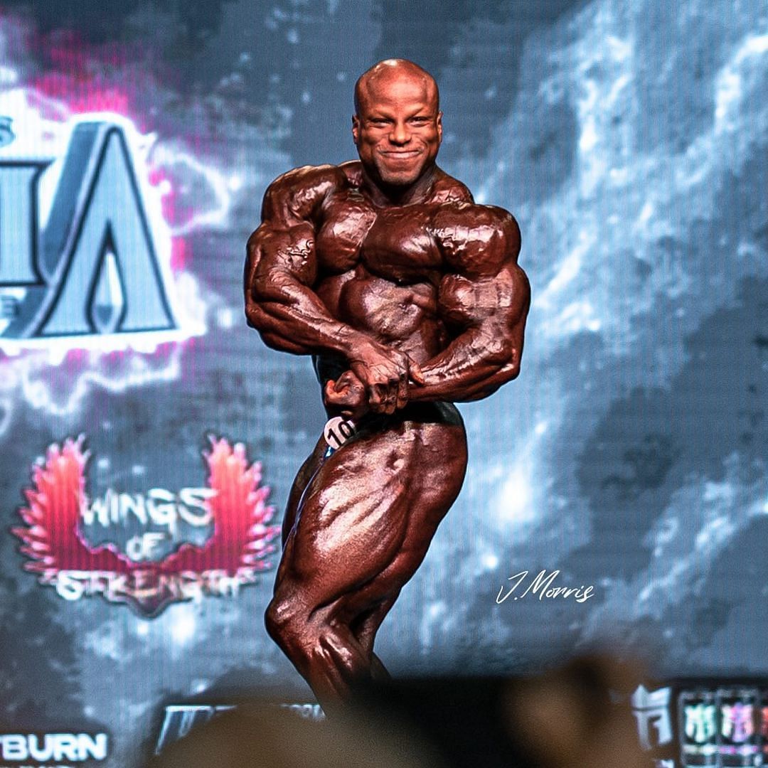 Shaun &#039;The Giant Killer&#039; Clarida poses on stage at the 2022 Mr. Olympia 212 final call before successfully claiming the title beating the likes of Angel Calderon Frias and Kamal Elgargni (Image via Instagram/@shaunclarida)