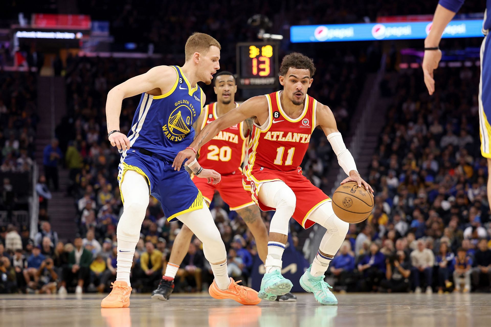 Golden State Warriors reserve guard Donte DiVincenzo defending Atlanta Hawks All-Star point guard Trae Young