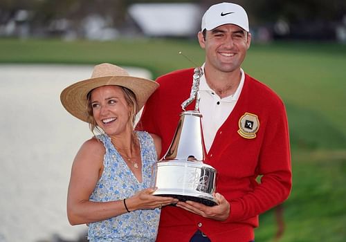 Scottie Scheffler posing along with his wife after the Arnold Palmer Invitational win