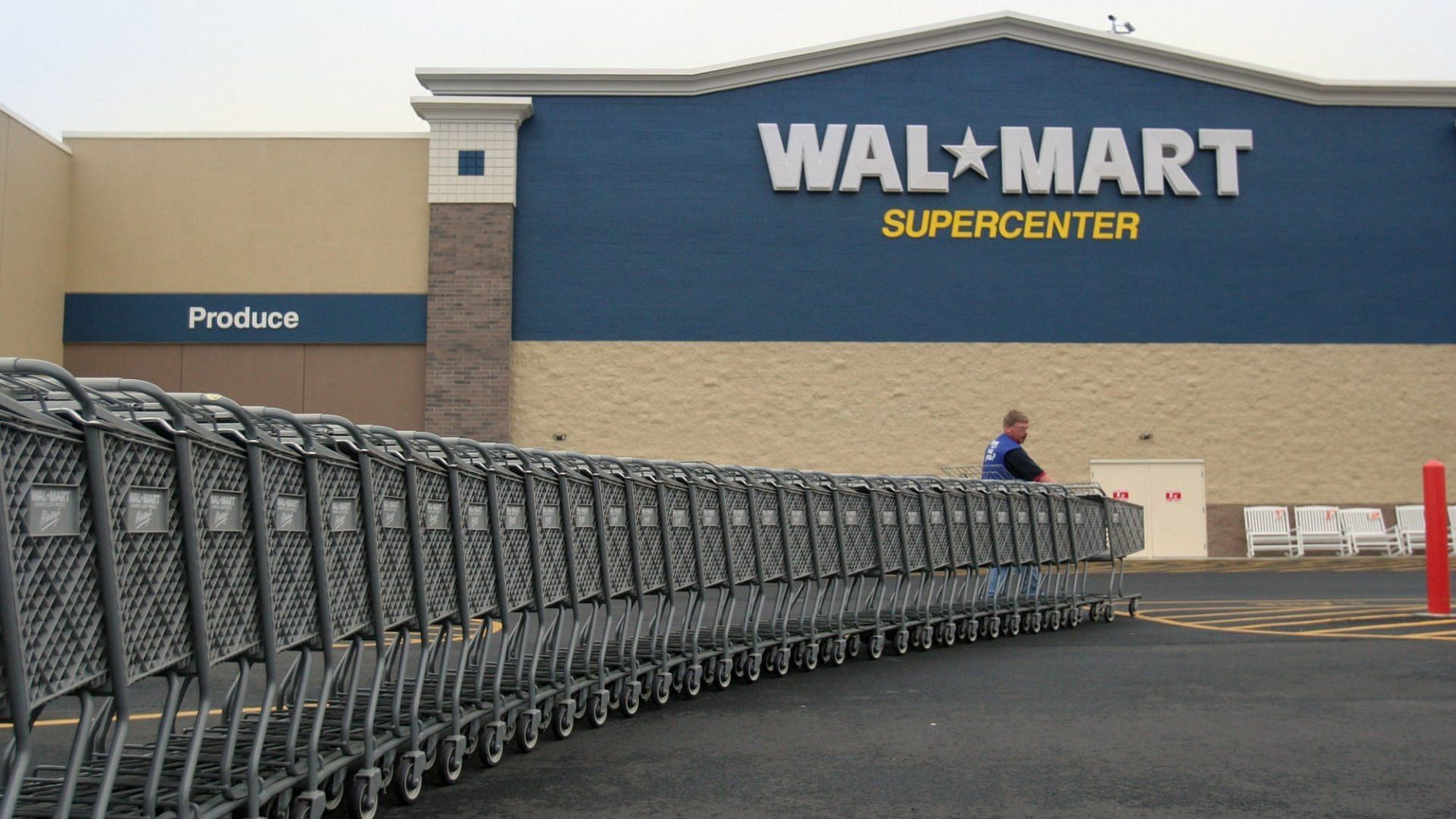 shopping carts are lined up outside a Walmart store in the United States (Image via Nikki Kahn/Getty Images)