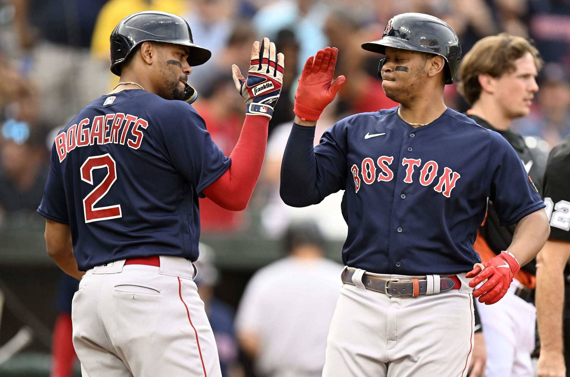 Rafael Devers celebrates with Xander Bogaerts after hitting a Grand Slam against the Baltimore Orioles