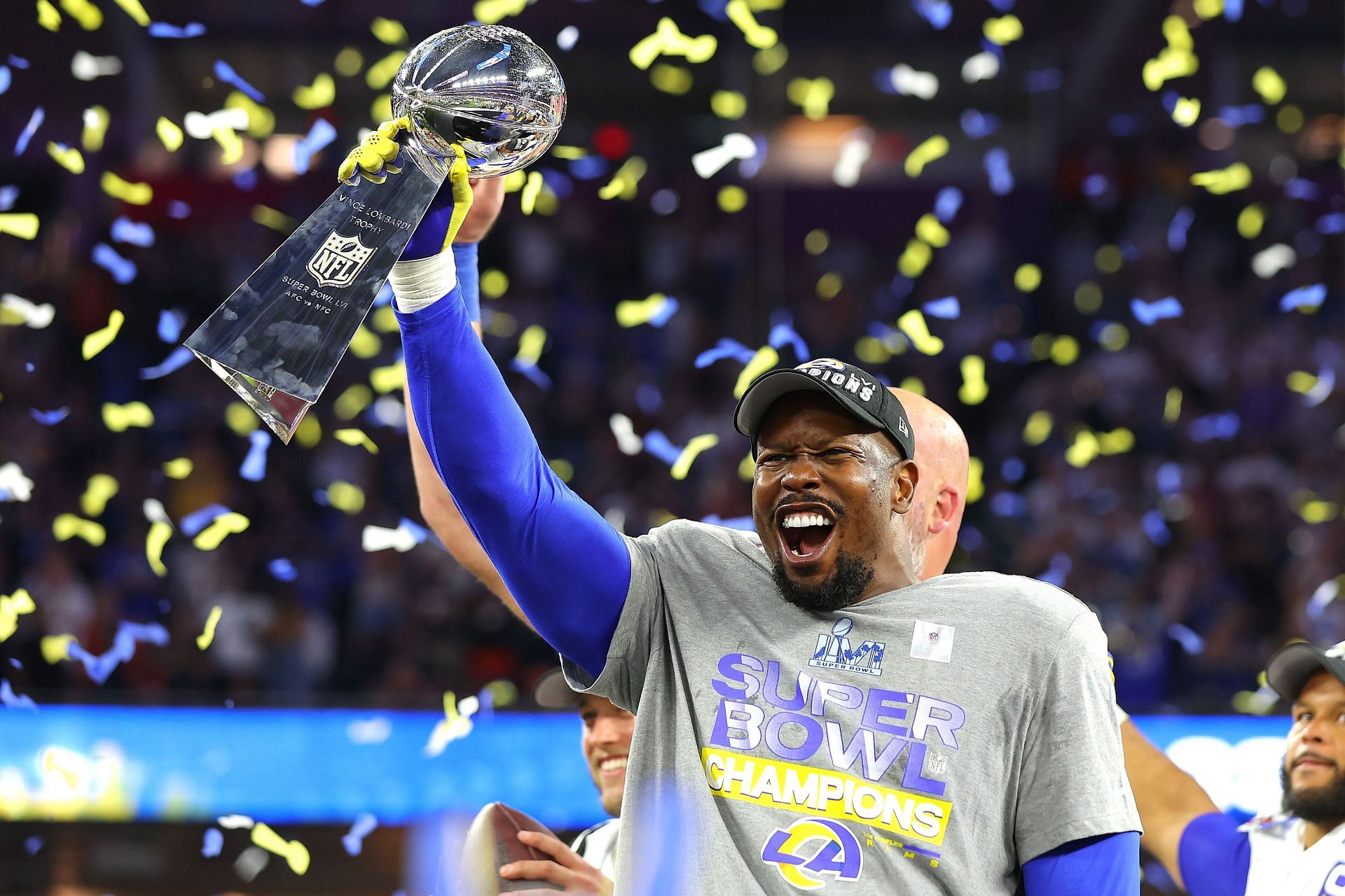 Los Angeles Rams linebacker Von Miller (40) holds up the Lombardi Trophy  while celebrating victory over