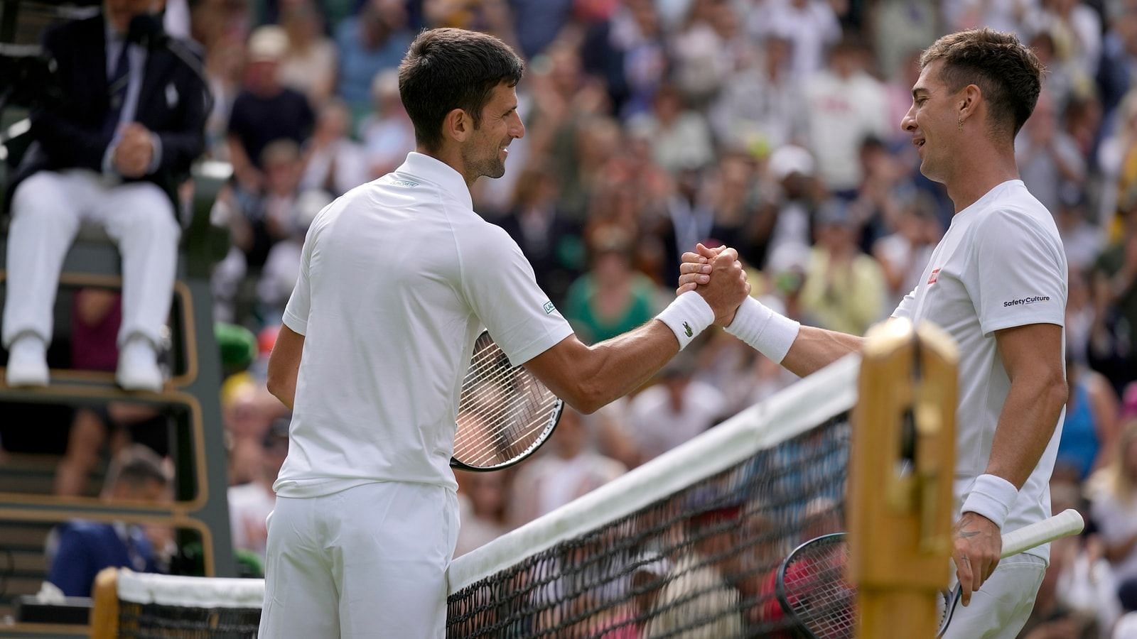 Novak Djokovic pictured with Thanasi Kokkinakis at the 2022 Wimbledon Championships.