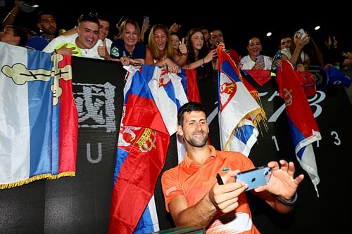 Novak Djokovic poses for selfies at an exhibition match before the Australian Open 2023