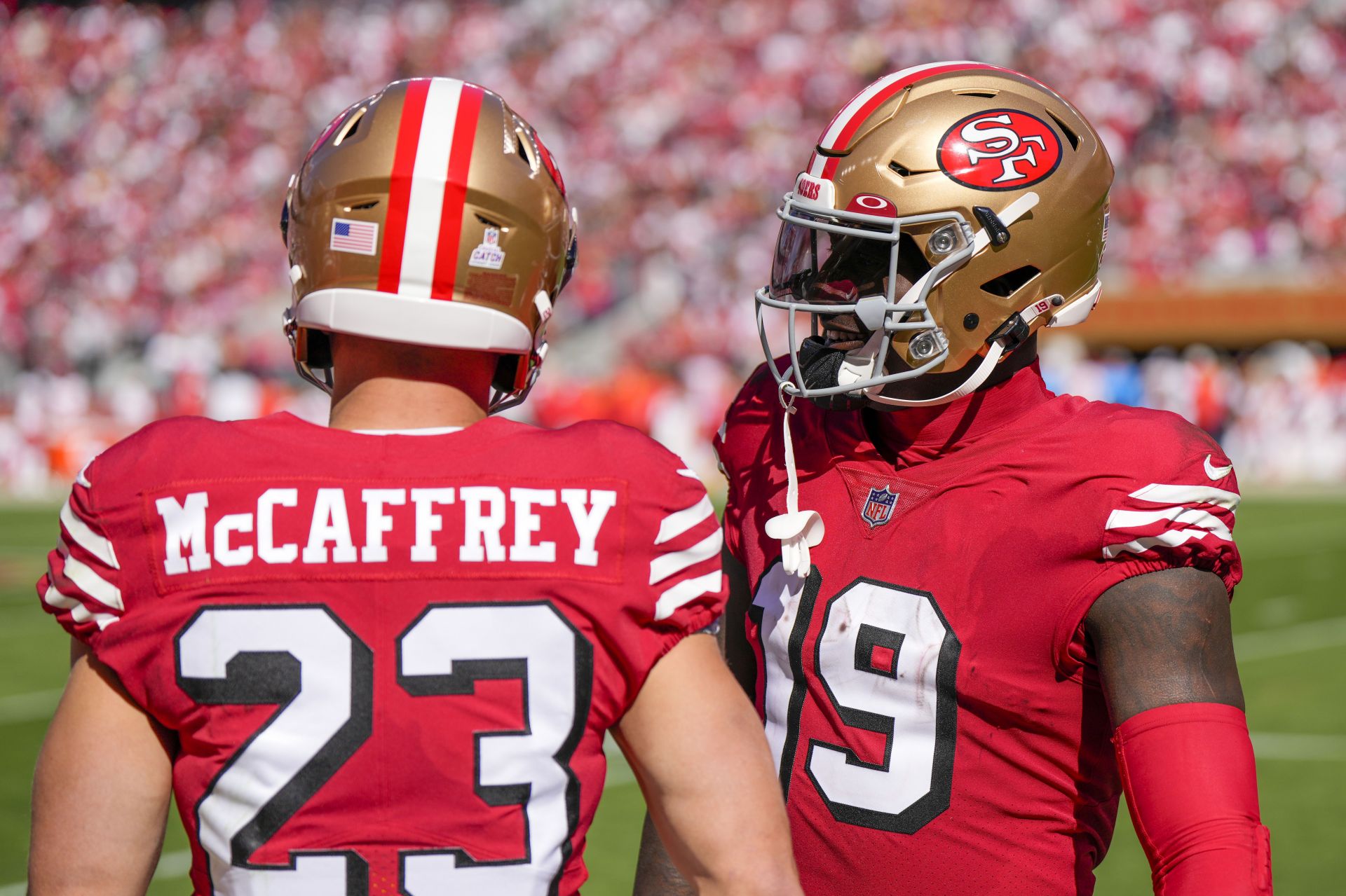 Brock Purdy of the San Francisco 49ers hands the ball off to Deebo