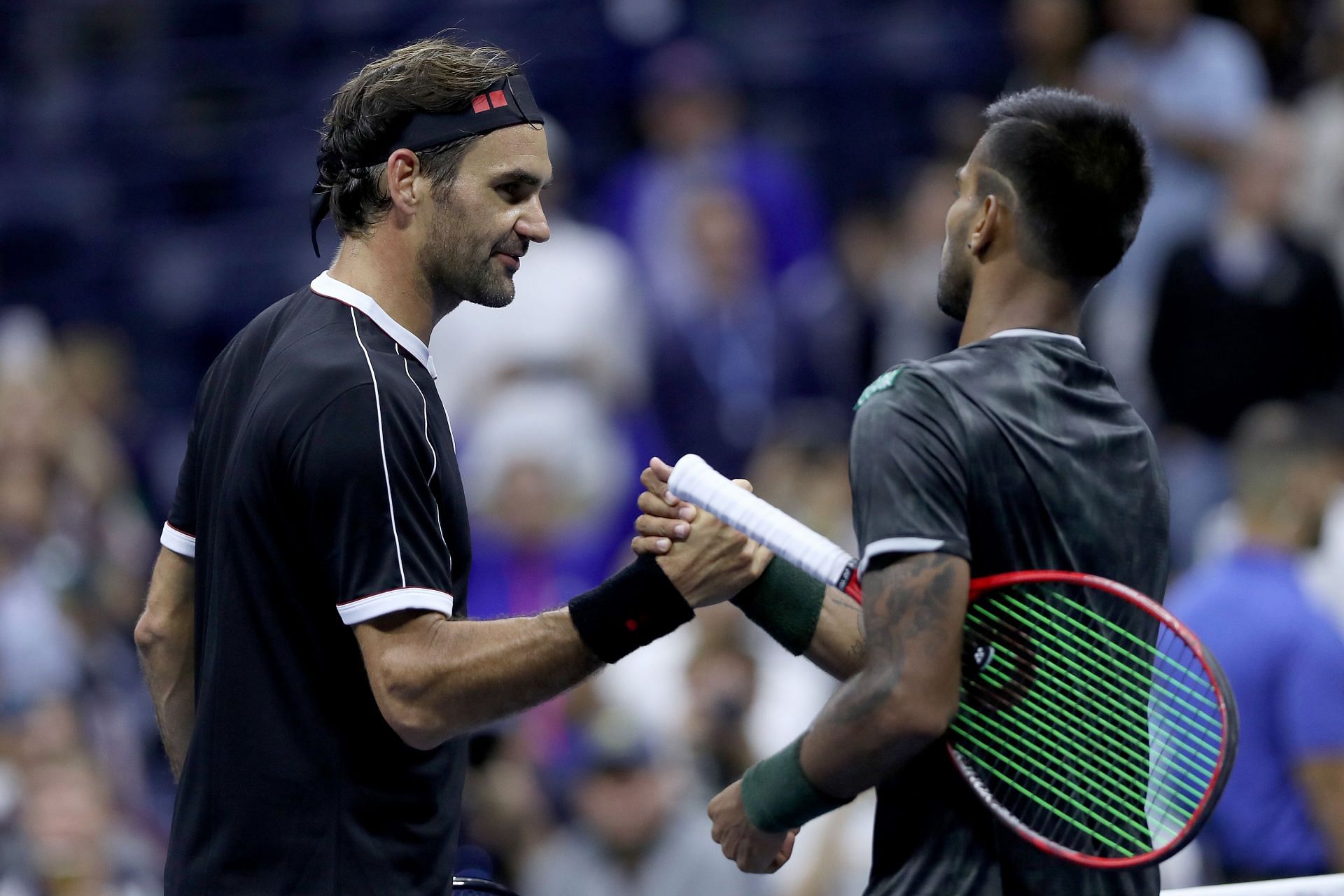 Roger Federer shakes hands with Sumit Nagal at the 2019 US Open