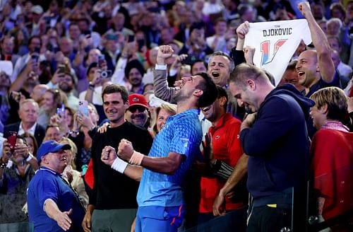 Novak Djokovic celebrates in his team's box after winning the Men's Singles Final match