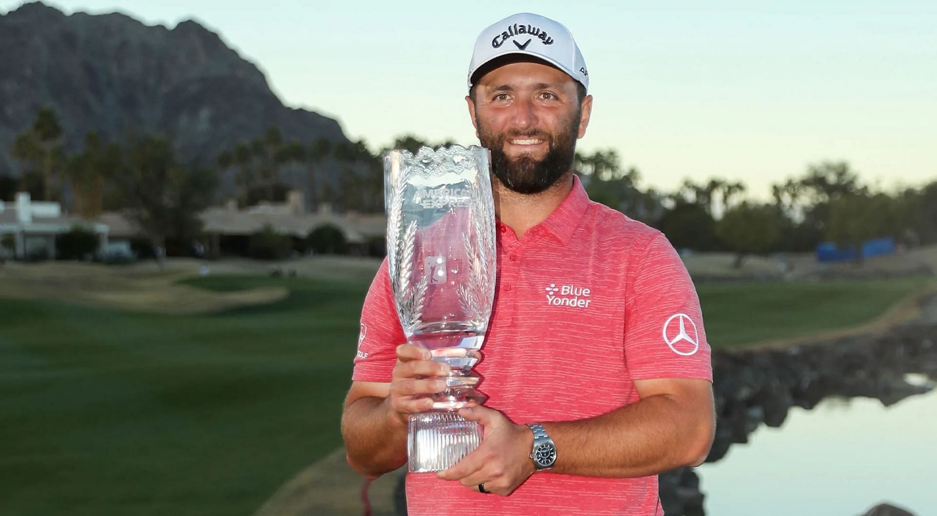 Jon Rahm poses with the American Express trophy