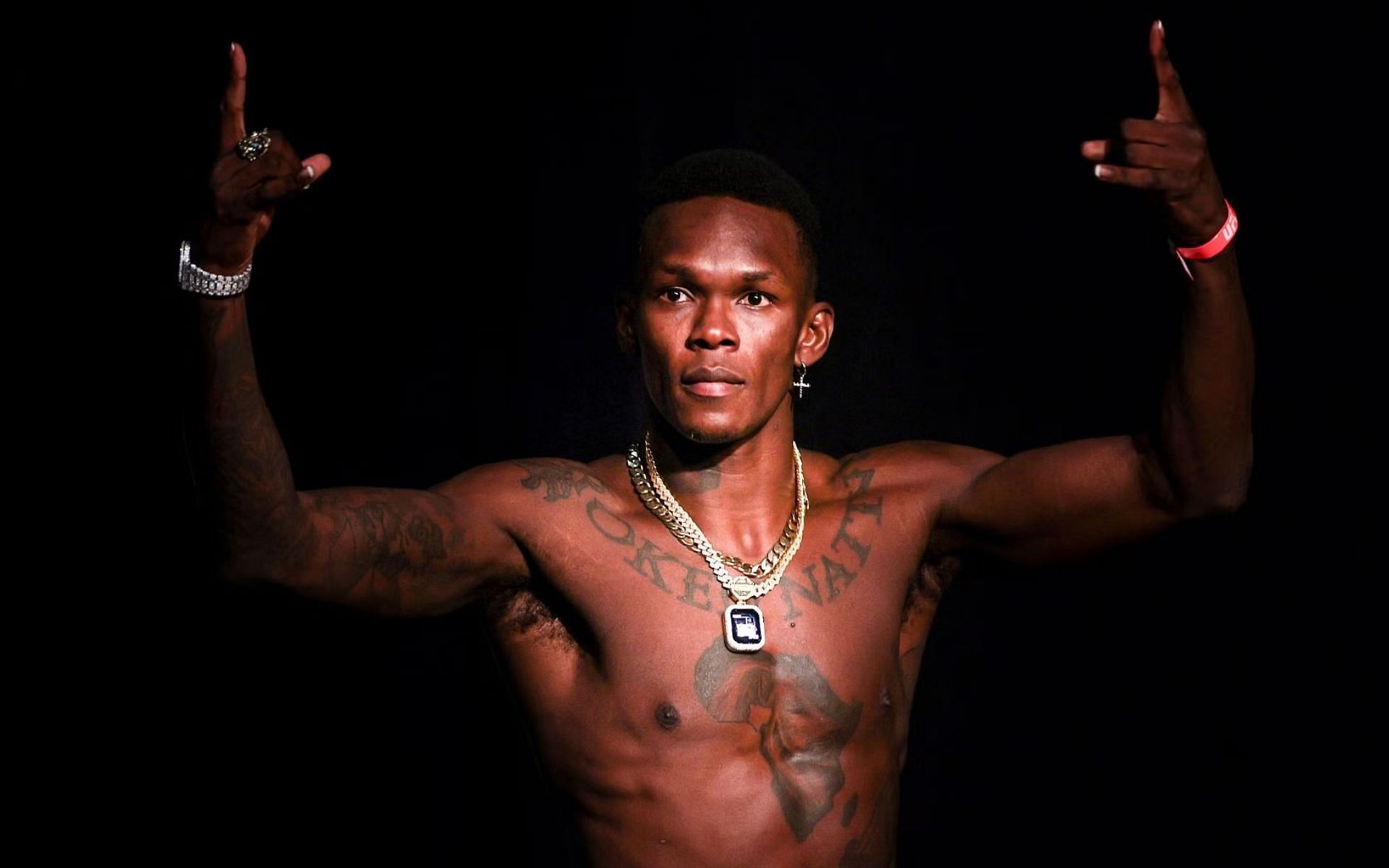 Israel Adesanya flaunts new neck tattoo, asks fans to decode its meaning