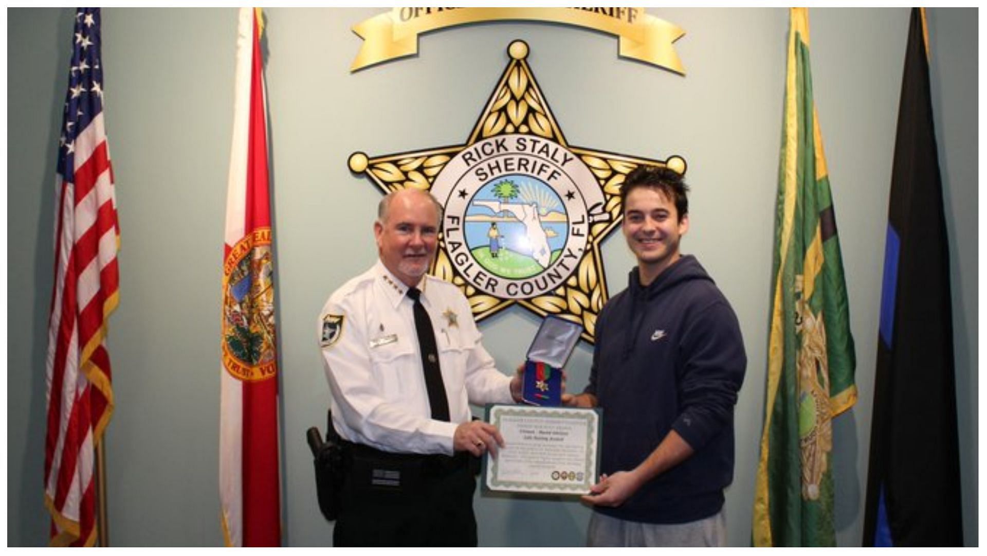 David is awarded a &quot;Lifesaving Award&quot; for saving a woman during gunfire, (Image via @FlaglerSheriff/Twitter)