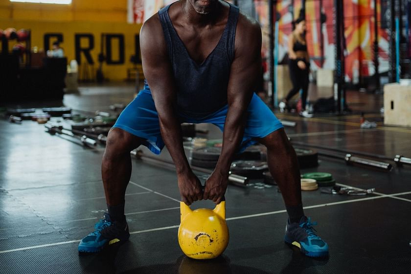 Person with kettlebell doing a sumo squat Stock Photo