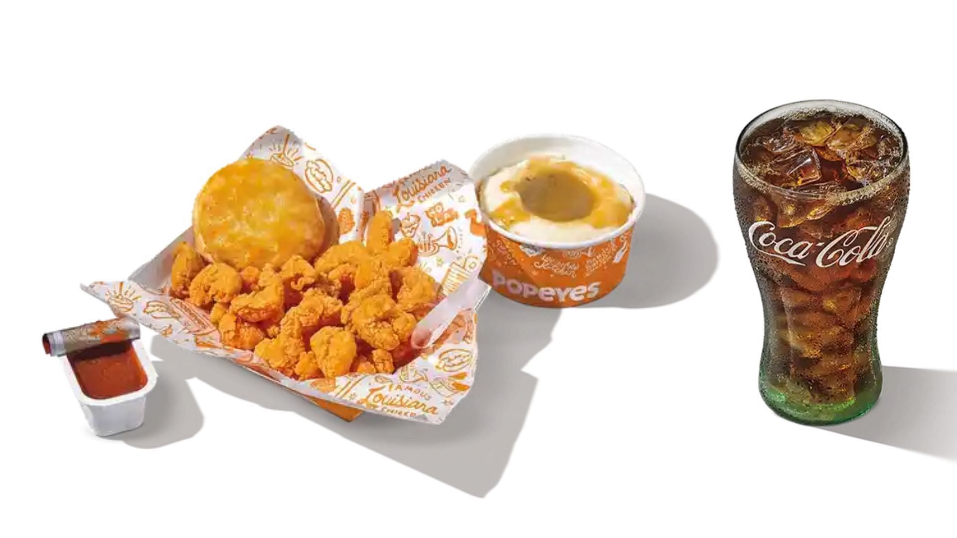 the 1/4 lb Popcorn Shrimp Combo comes with a regular side, a small drink of your choice, and a biscuit, and is available at a suggested price of $10.99 (Image via Popeyes)