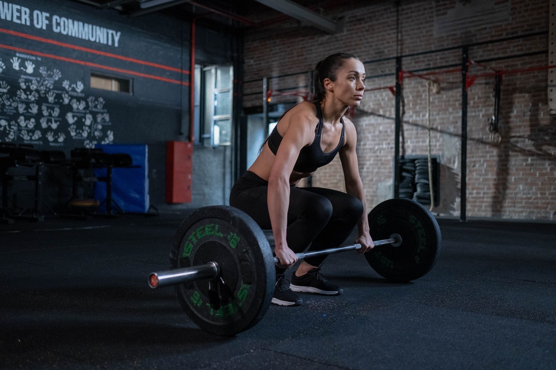 Barbell roll out challenges your balance. (Photo via Pexels/cottonbro studio)