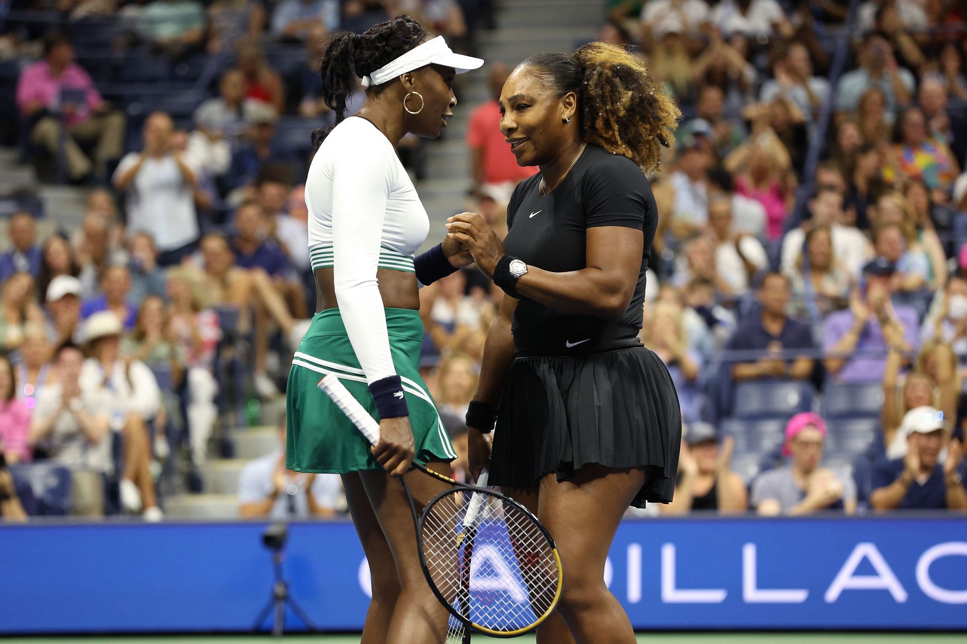 Serena and Venus Williams in action at the 2022 US Open.