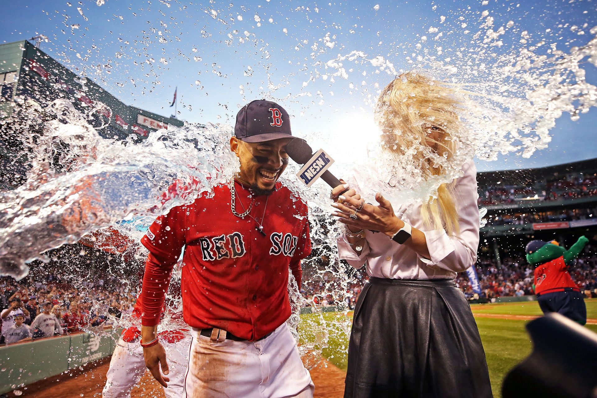 Mookie Betts of the Boston Red Sox and NESN host Guerin Austin are doused in Gatorade.